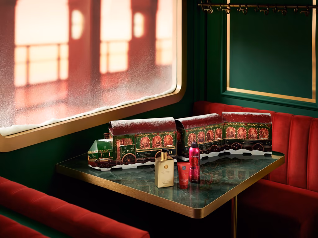 The train on the carriage table with a fragrance bottle and two products beside it