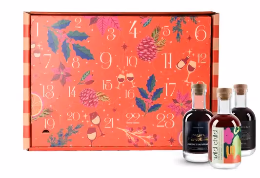 The red calendar box with three mini bottles standing at its side