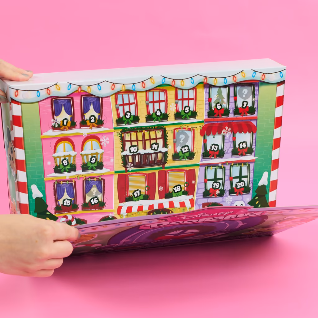 The house-shaped box folding open on a pink background