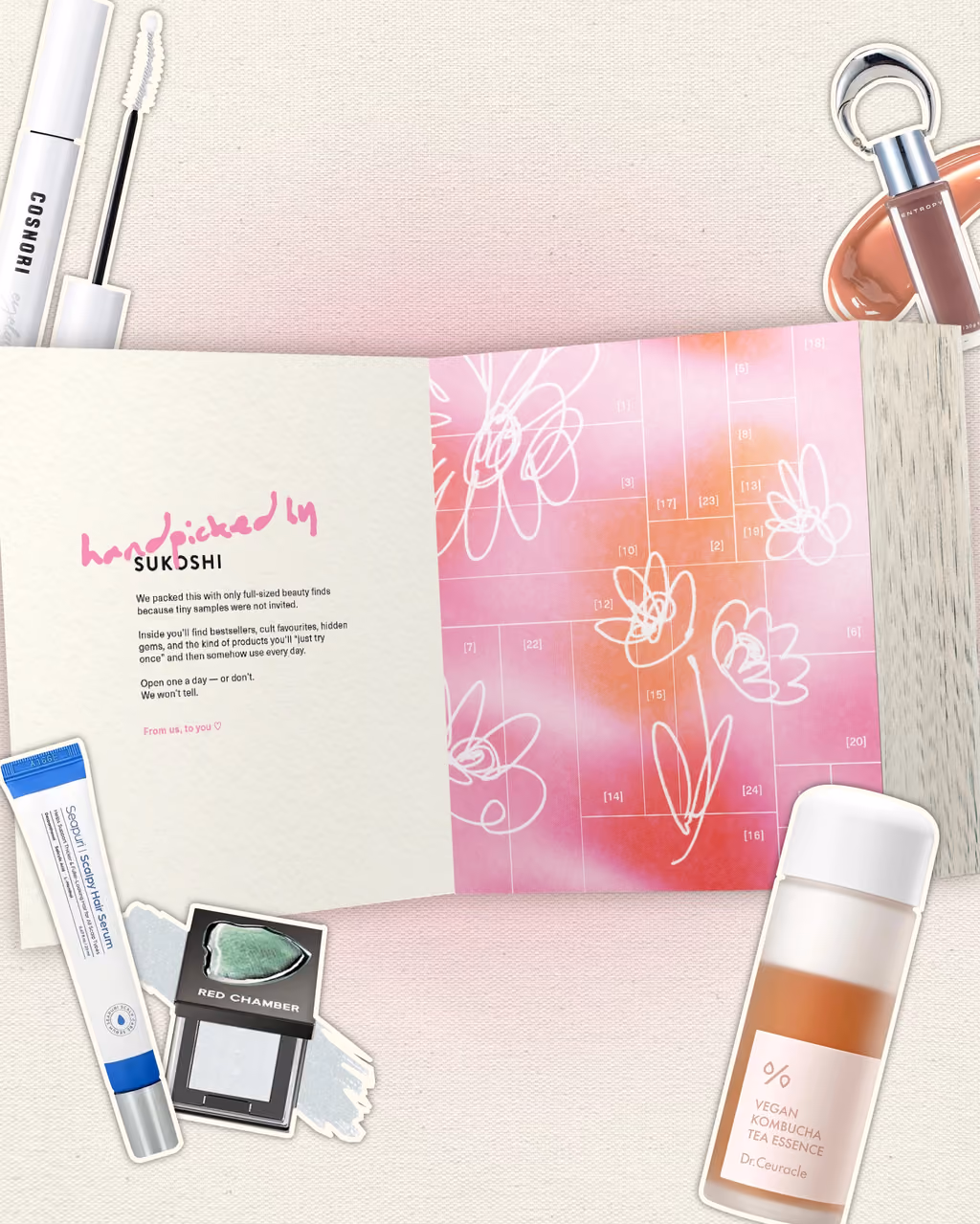 The Sukoshi 2026 calendar open, with Korean skincare and makeup beside it