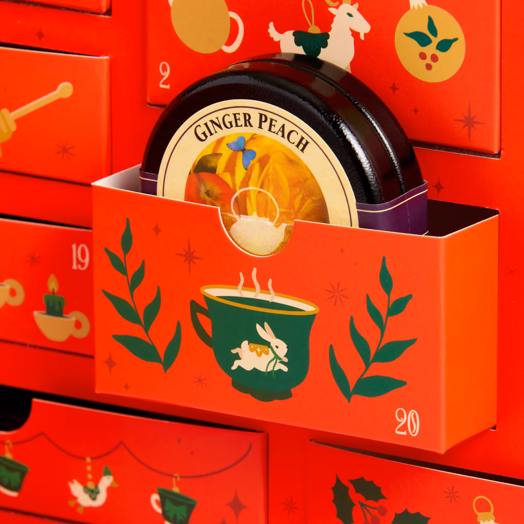 A window open on a round Ginger Peach tea tin