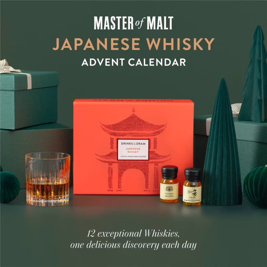 The red pagoda-printed mini box on a green set beside a tumbler and two drams
