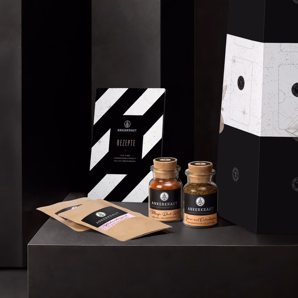 Two cork jars, two refill sachets and the recipe booklet beside the lighthouse