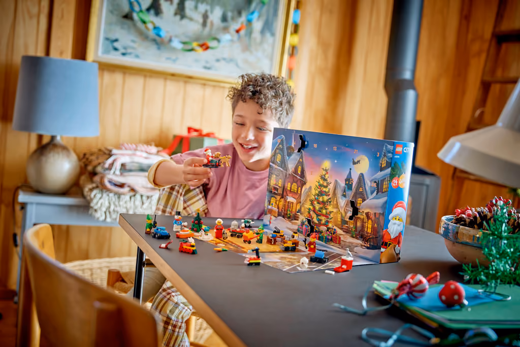 A child building the day's LEGO City 2026 surprise on the opened playmat