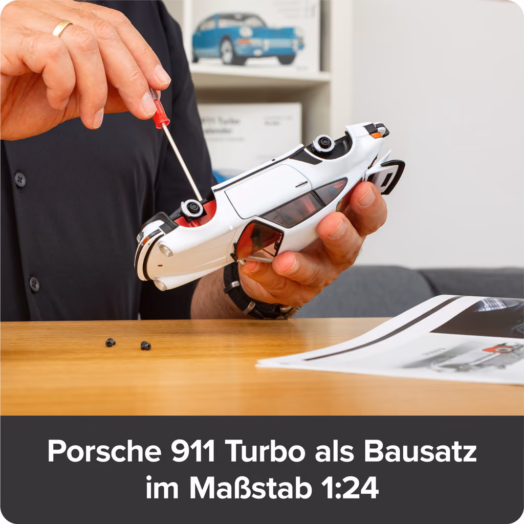 Hands screwing the underside of the white 911 body together