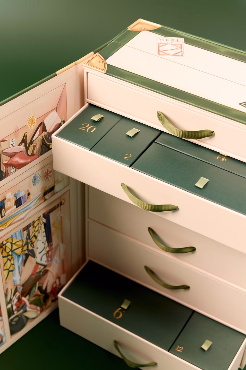 Close-up of the numbered green-and-cream drawers inside the Vogue trunk