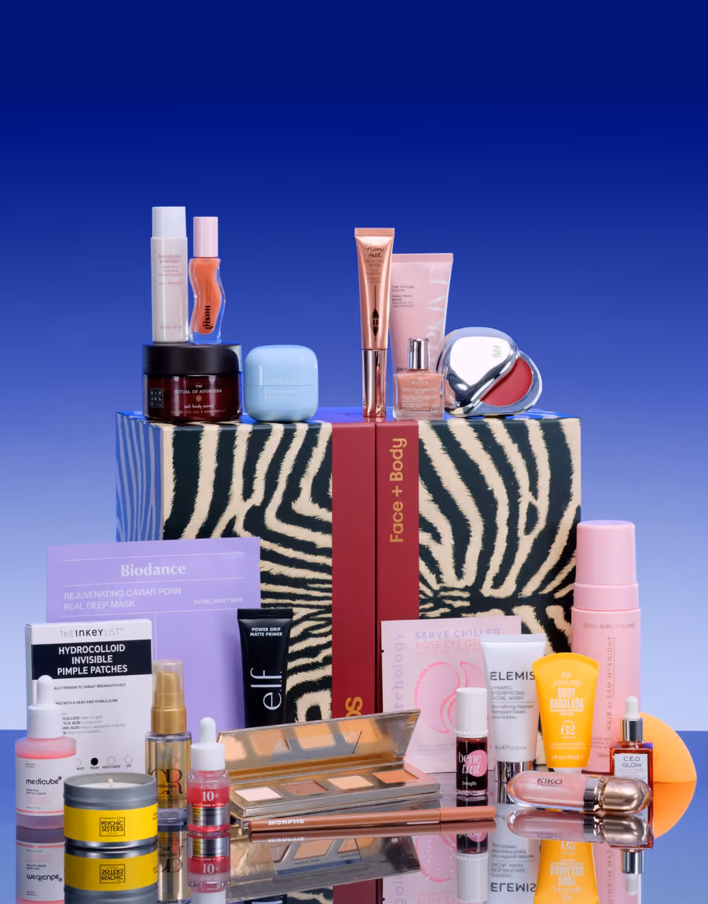 The zebra-print ASOS Face + Body 2026 box with its 25 products stacked in front and on top of it