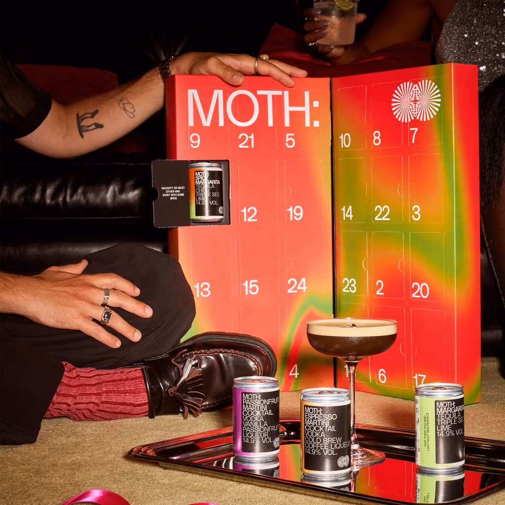 A can drawn from one of the doors, with an Espresso Martini and cans on a tray