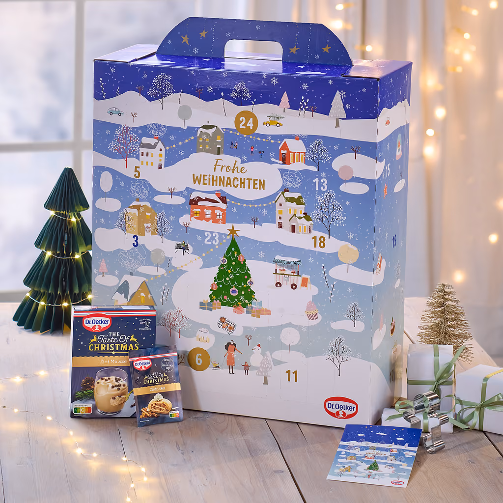 The back of the Dr. Oetker box, Frohe Weihnachten, beside a cinnamon mousse, a baking mix and a star cookie cutter