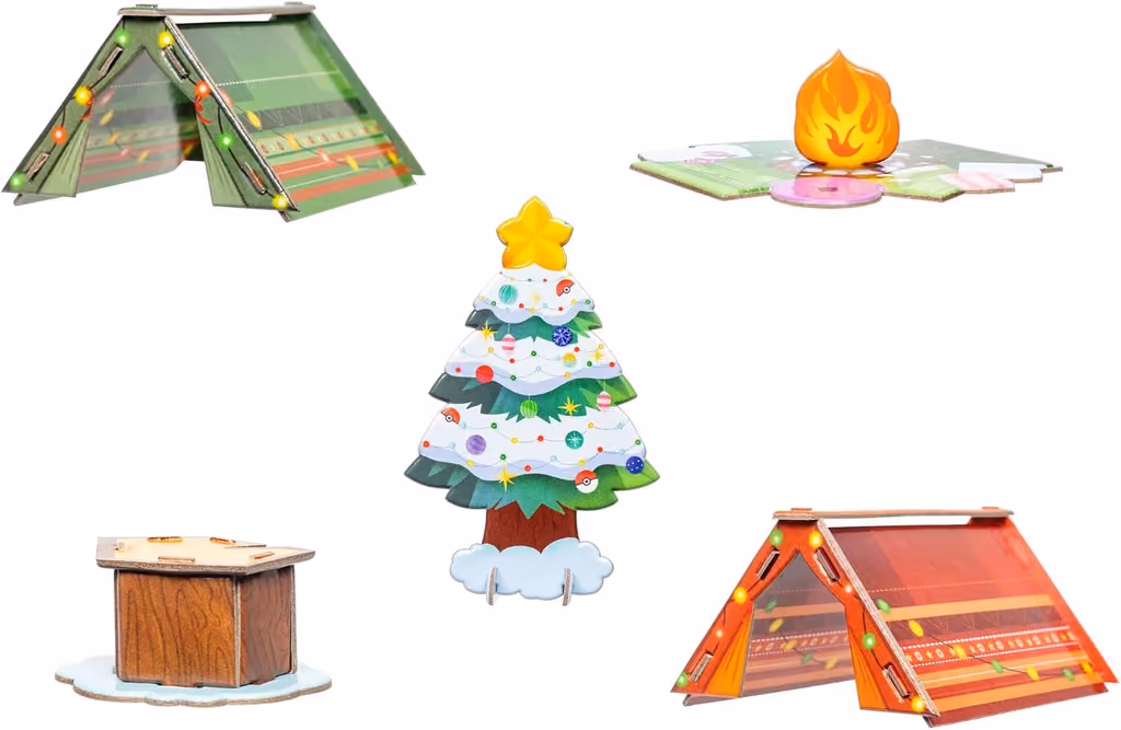 The nineteen holiday figures, two tents, a campfire, a tree and a stump laid out
