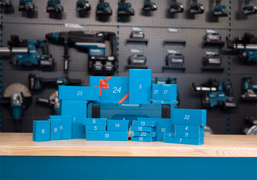 The 24 numbered Makita door boxes stacked on a workbench in front of a wall of tools