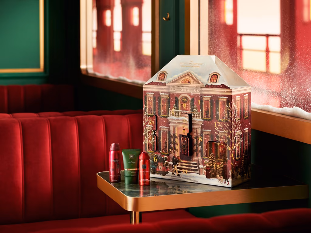 The house on the carriage table with a body oil and a shower foam beside it