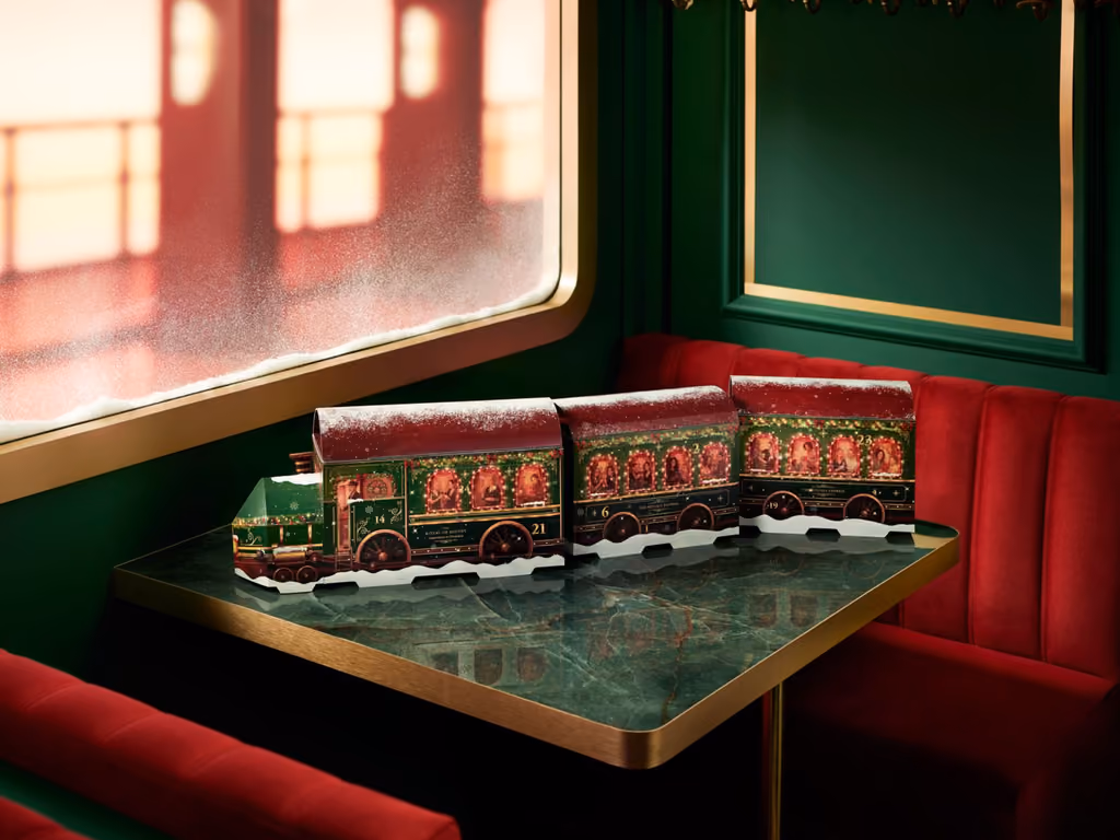 Locomotive and carriages on a marble table in a green railway carriage