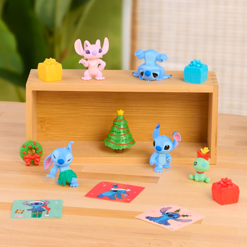 Figures and presents arranged on a wooden shelf
