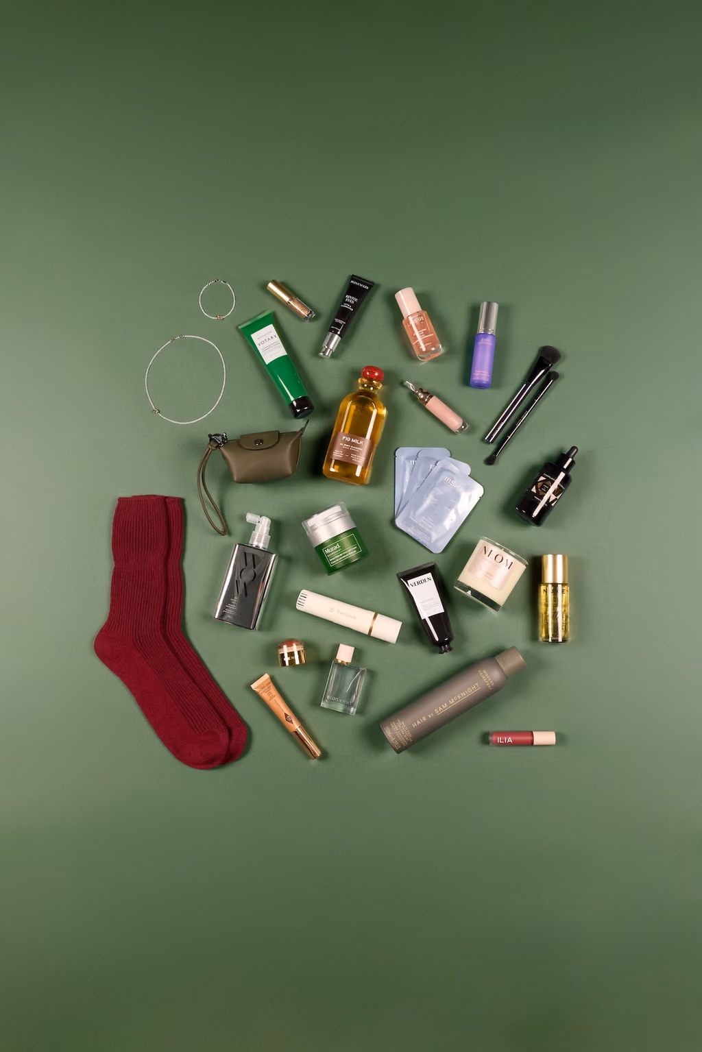 All the products from the Vogue Festive 2026 calendar laid out on green, socks and jewellery among them