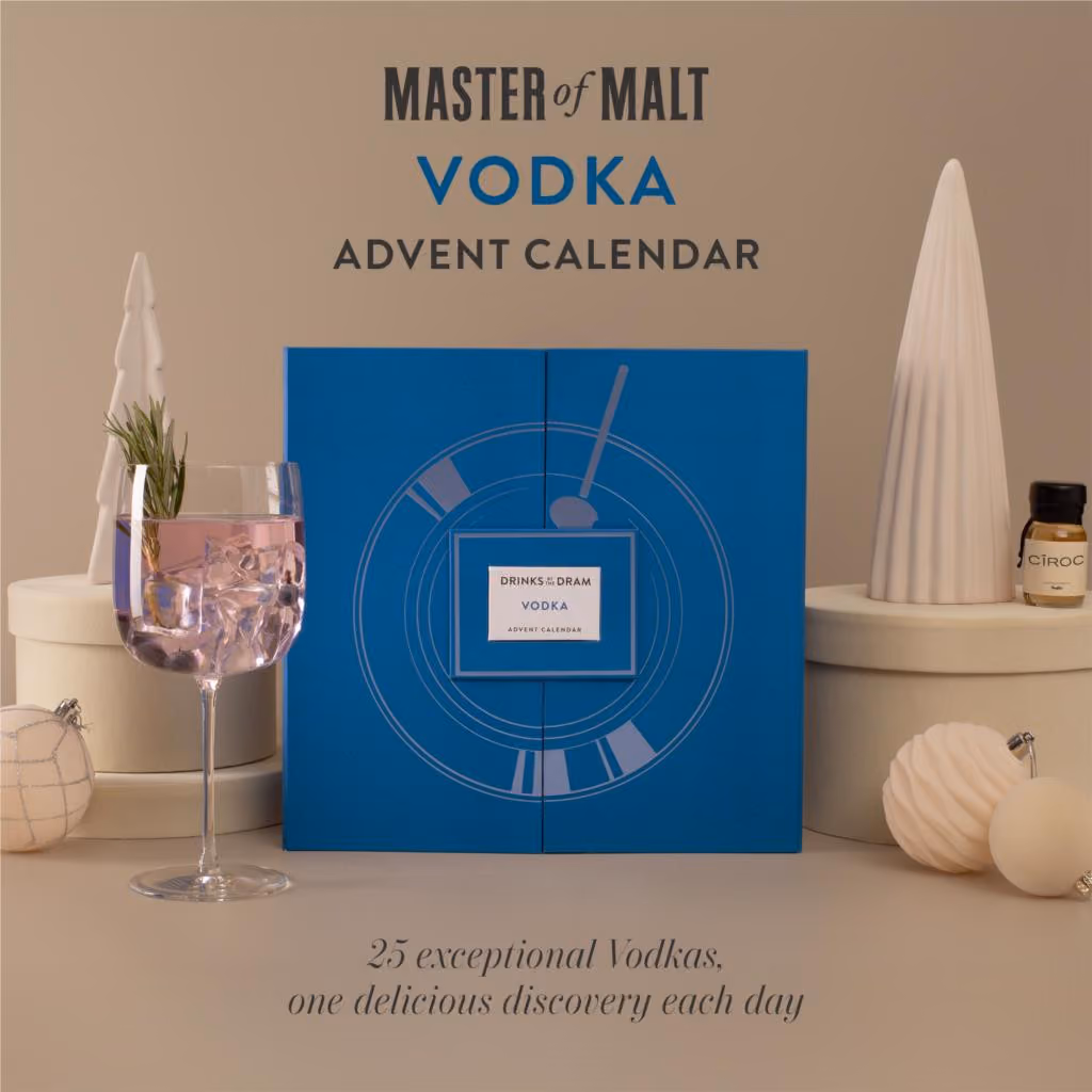 The blue box with a printed Martini glass on a beige set beside a cocktail