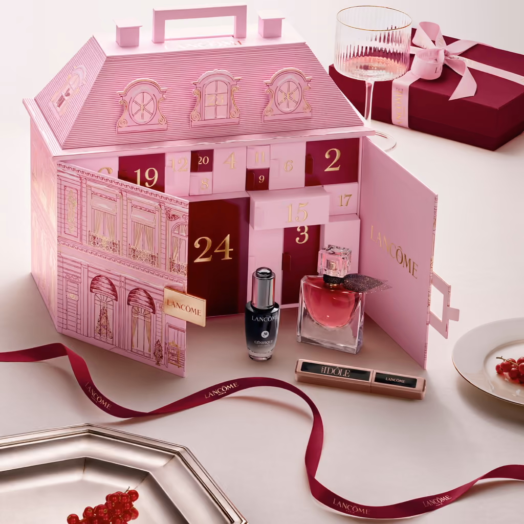 The Lancôme palace on a table with door 24 open and a La Vie Est Belle bottle beside it