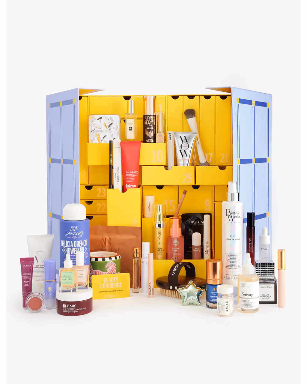 The Selfridges 2026 box open to its lilac and yellow drawers, with products in the trays and on the floor