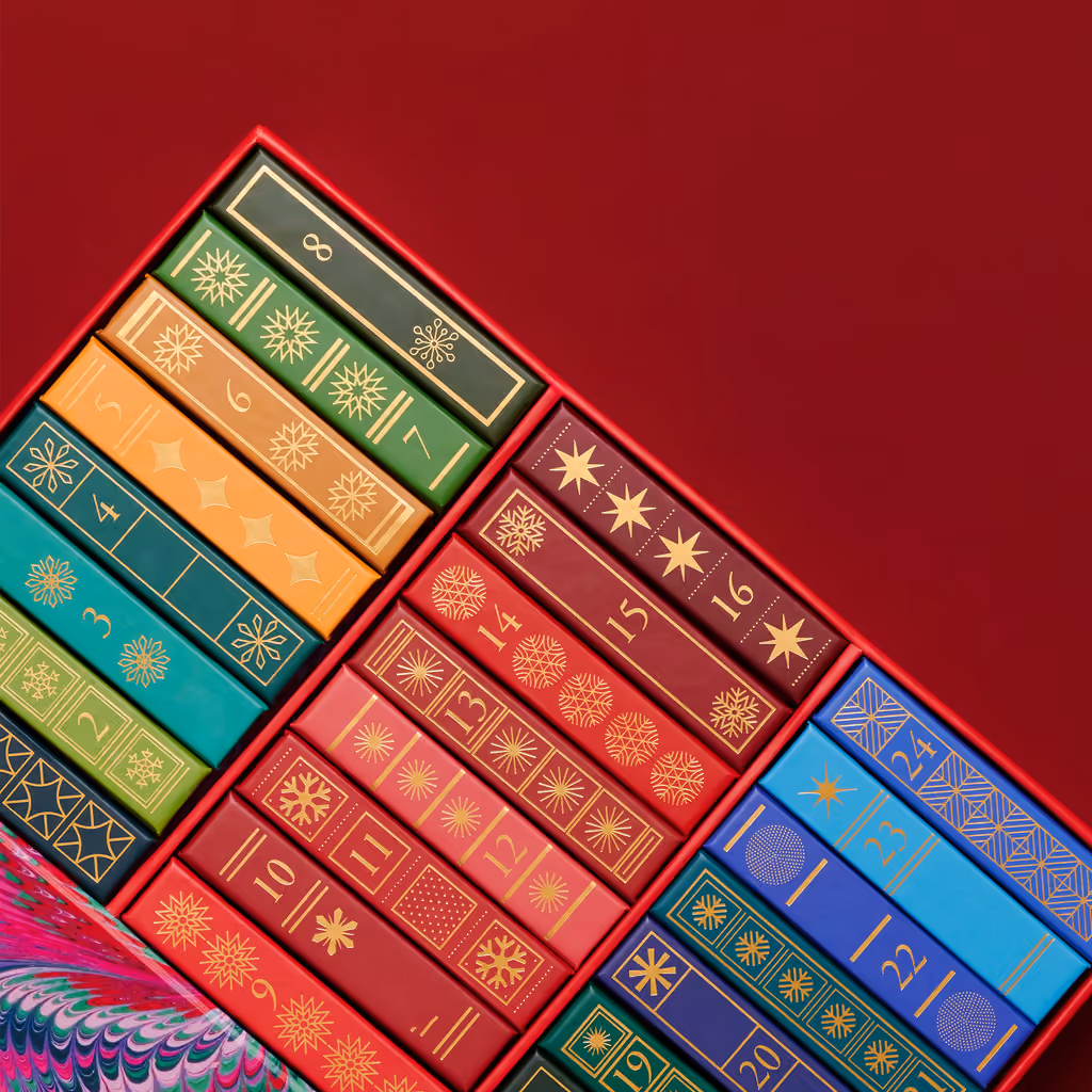 The slipcase open, the miniature books fanned out inside it