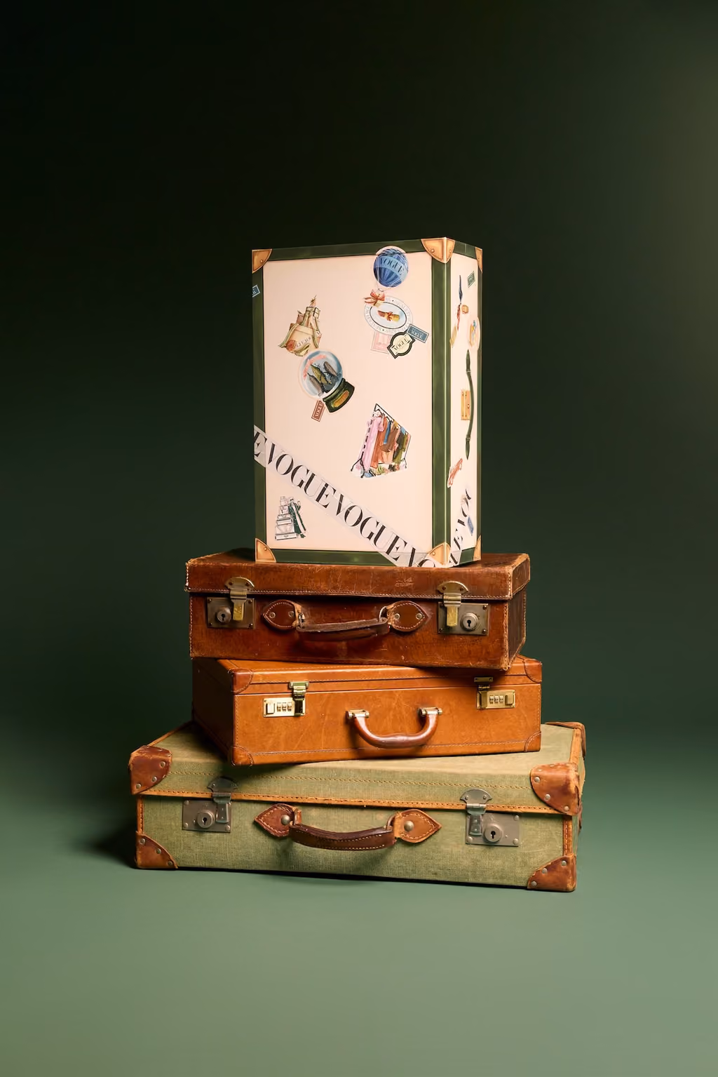The Vogue trunk stacked on top of two vintage suitcases