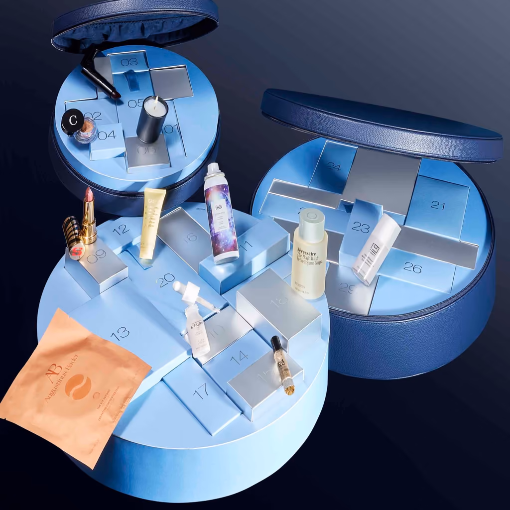 The two navy cases open on a blue ground, numbered drawers pulled out with products standing in front