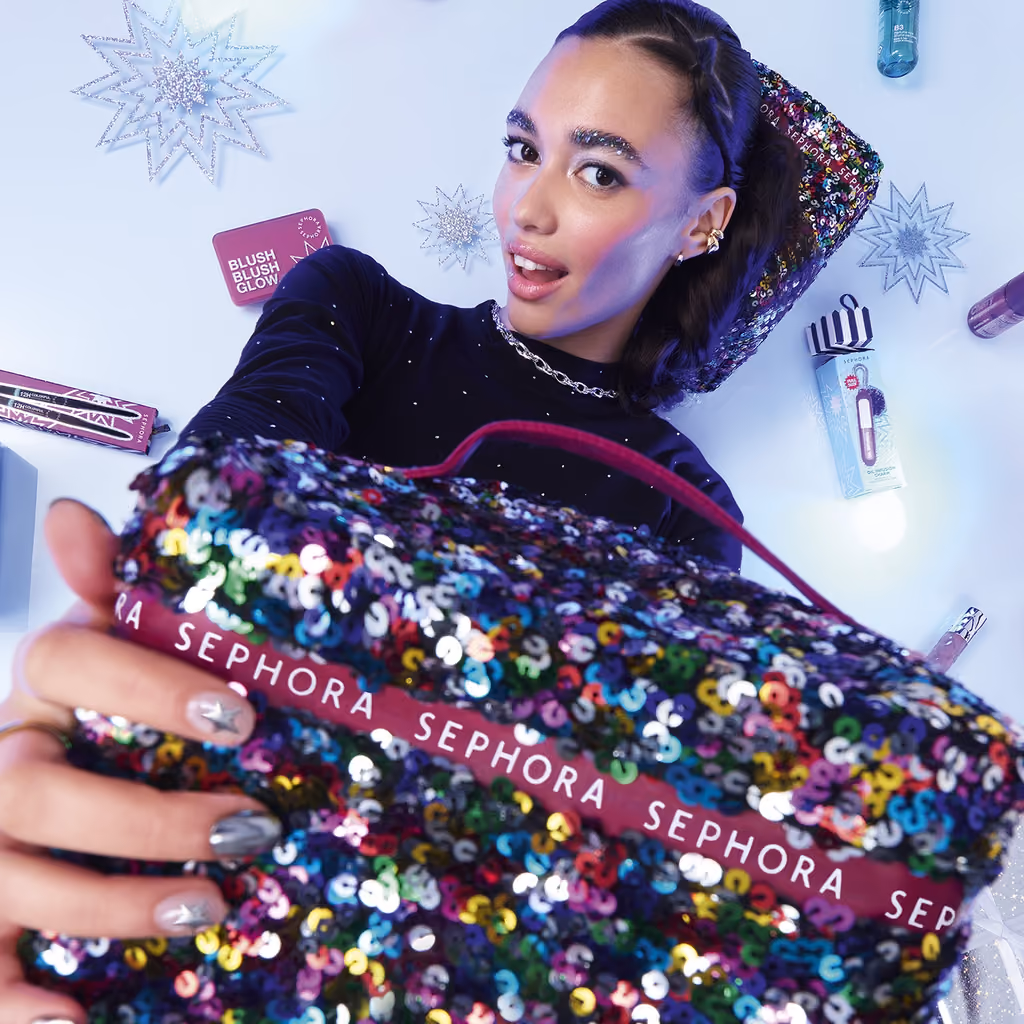 A model holding the sequinned Sephora Collection Premium 2026 vanity case