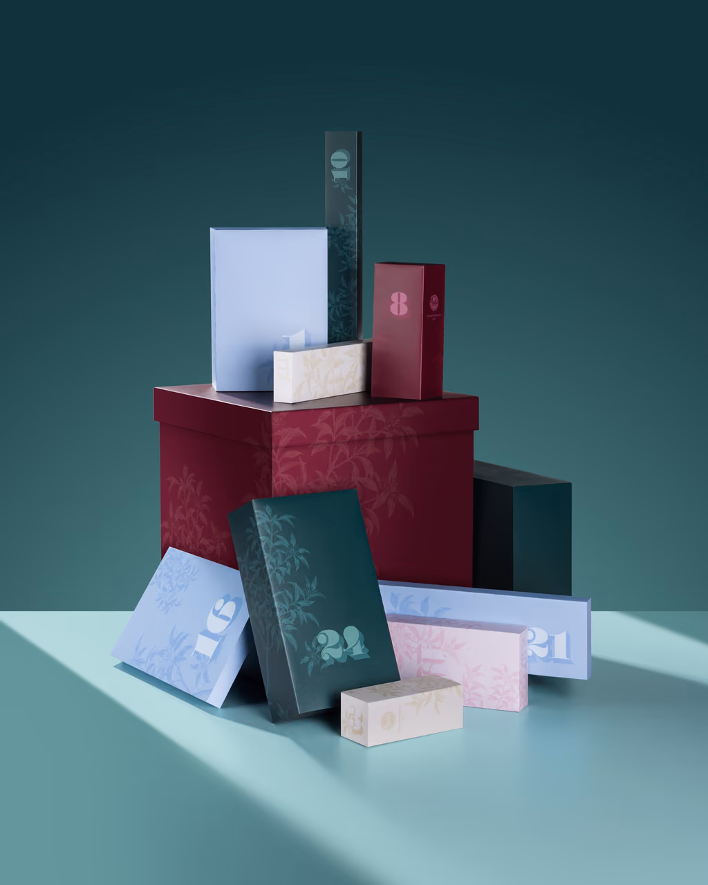 The numbered door boxes in blue, green, pink and cream stacked on and around the plum gift box