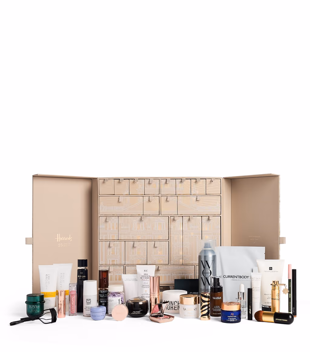 The Harrods Beauty 2026 calendar open to its 25 drawers, with the products arranged in front
