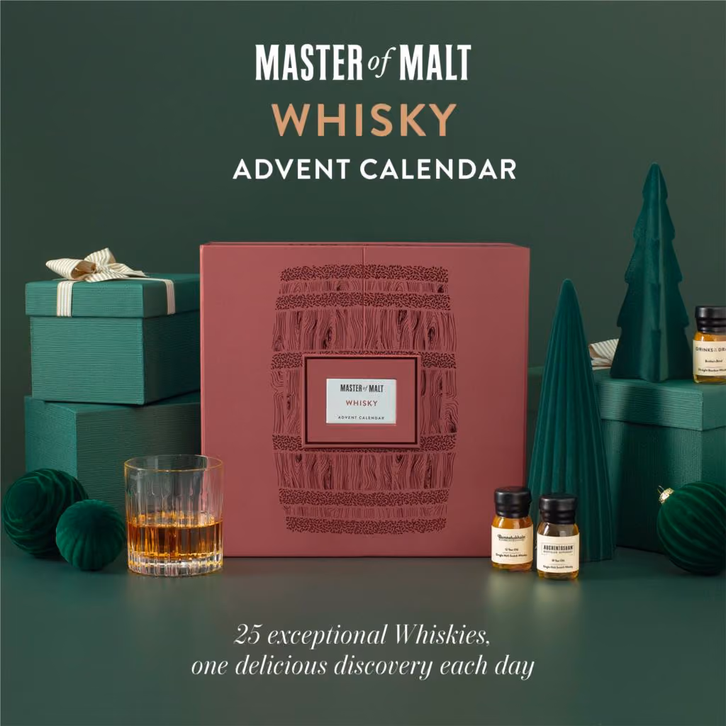 The burgundy Master of Malt whisky calendar on green with a tumbler and two 30 ml drams beside it