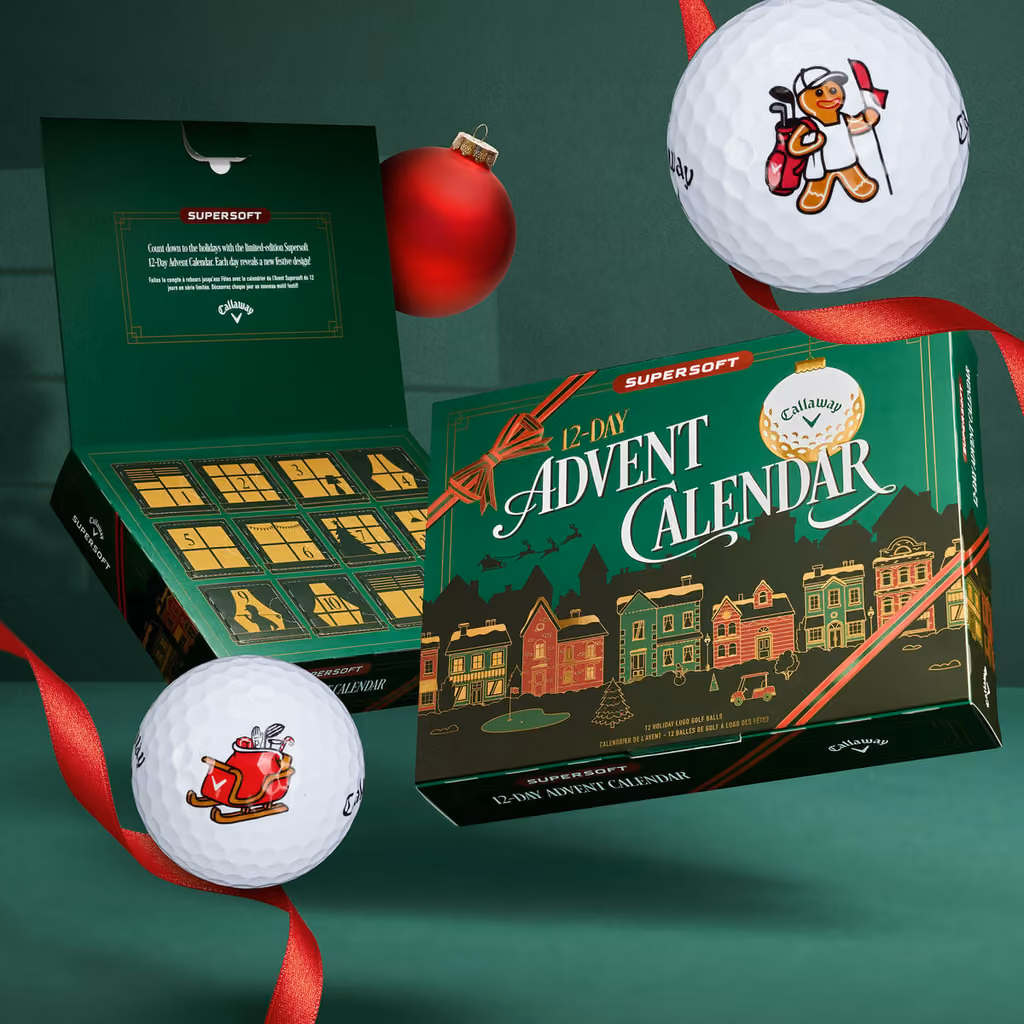 The box open with its twelve numbered doors, a sleigh ball and a gingerbread caddie ball beside it