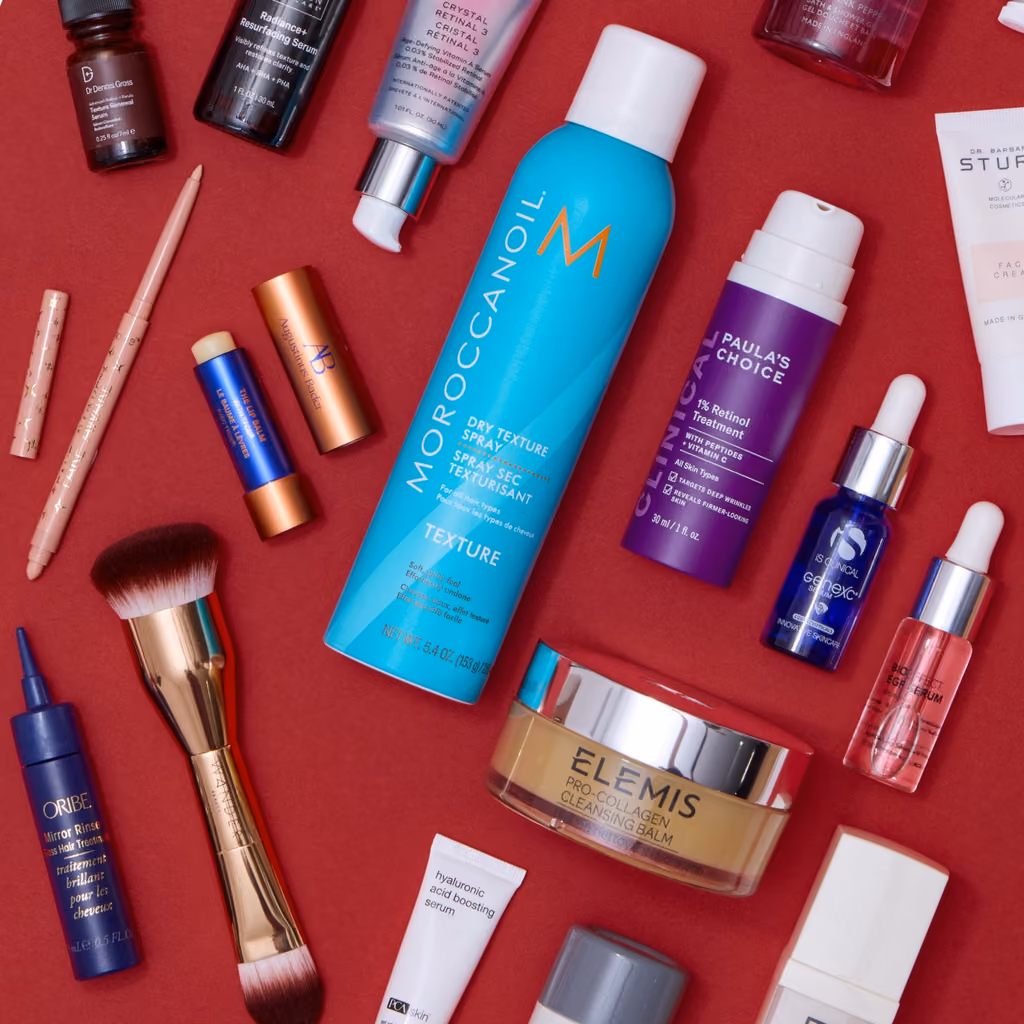 Flat-lay of the calendar's skincare, hair spray and makeup on red