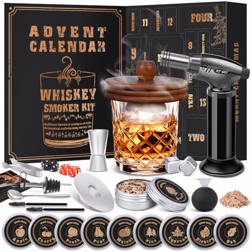 The whiskey smoker kit — glass, torch, wood chips and tools — laid out in front of the open calendar