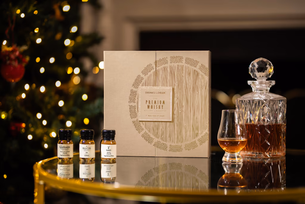 The box on a gold table with three drams and a decanter, a Christmas tree behind