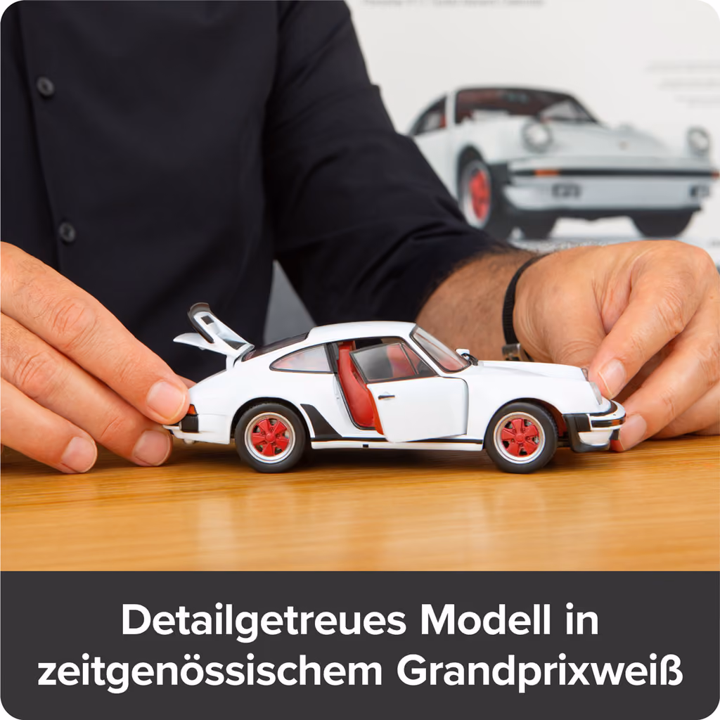 The finished white 911 Turbo model held in two hands