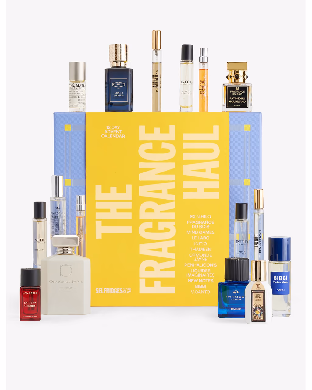 The yellow Fragrance Haul box with the sixteen perfume bottles standing on top of it and around its base