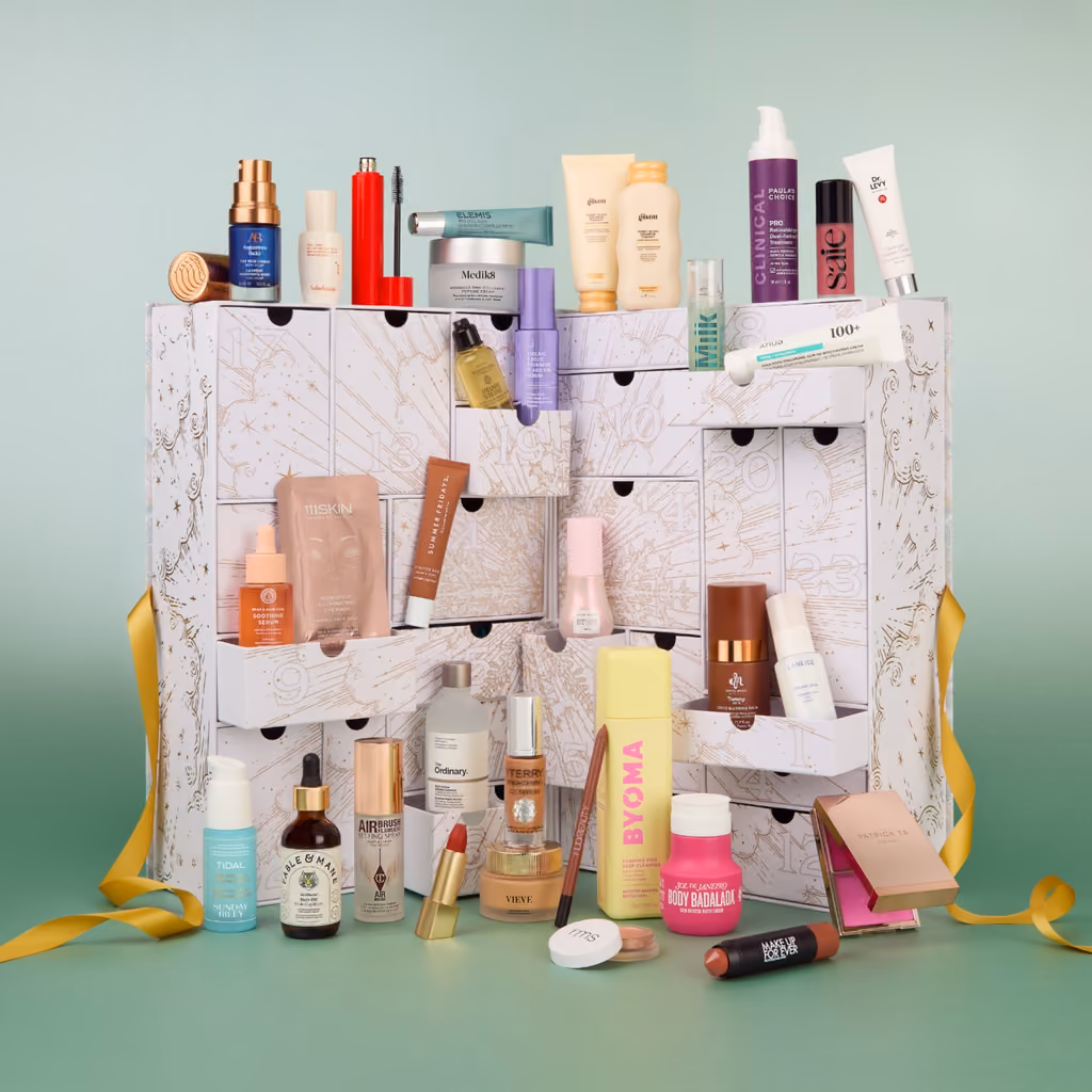 The Cult Beauty Signature Edition box open on green, products standing on and in front of its drawers