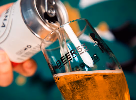 Beer being poured from a can into the Beer52 tasting glass
