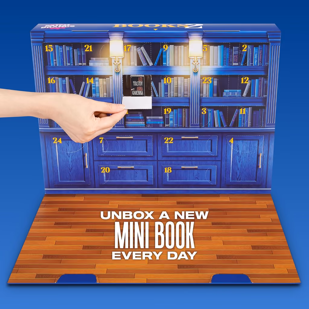 A hand lifting a tiny book out of one of the numbered doors